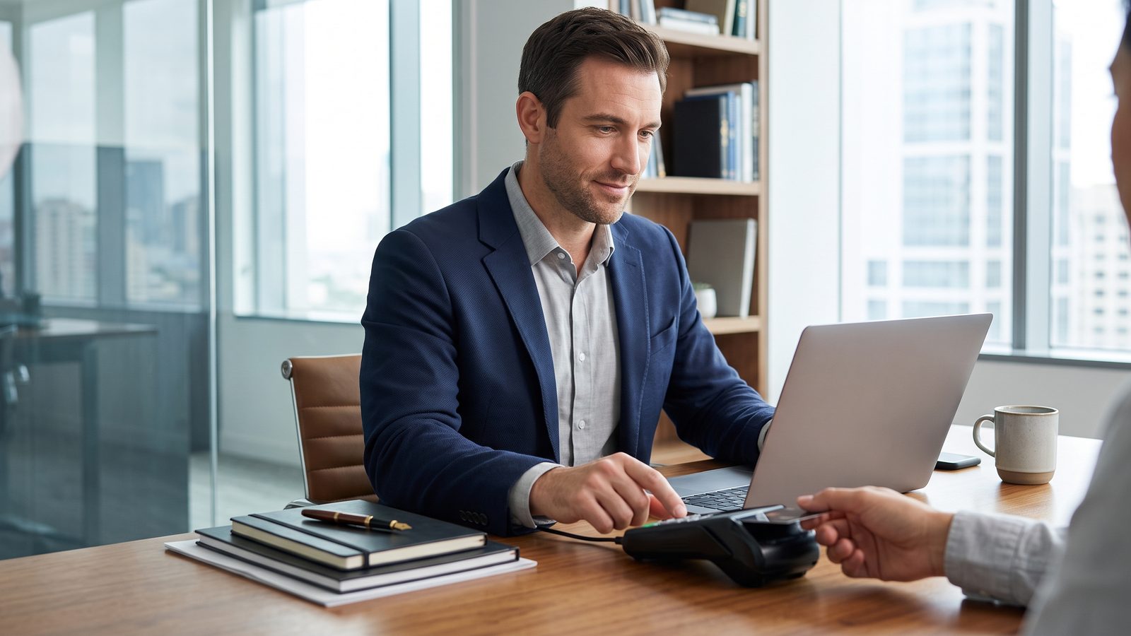 Consultant sending an invoice from a laptop with a Square card reader